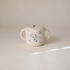 mushie Silicone Snack Cup | Spill Proof Food Container for Toddler and Baby (Lilac Flowers)