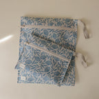 mushie Water Resistant Wet Bags | Large & Small Reusable Storage Bag for Baby Items and Travel | Zippered Pockets with Handle | Machine Washable, Set of 2 (Blue Flowers)